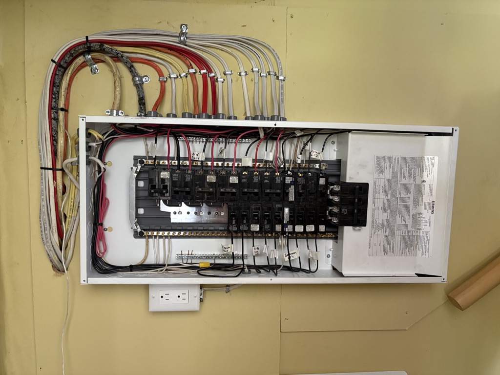 Fully wired open electrical panel with colour-coded breakers, installed by Bay Road Electrical